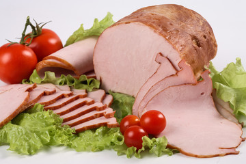 Slised ham with vegetables. Still life.