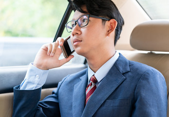 Businessman talking on the phone in car