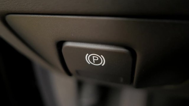 Parking brake button pulled in modern car (Volvo)