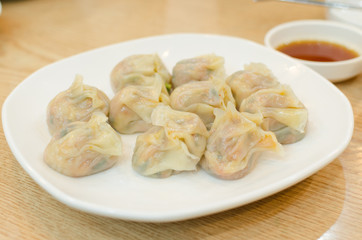 japanese food, gyoza, on white dish with sauce
