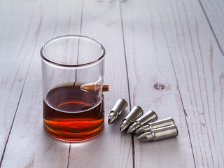 Whiskey glass with bullet