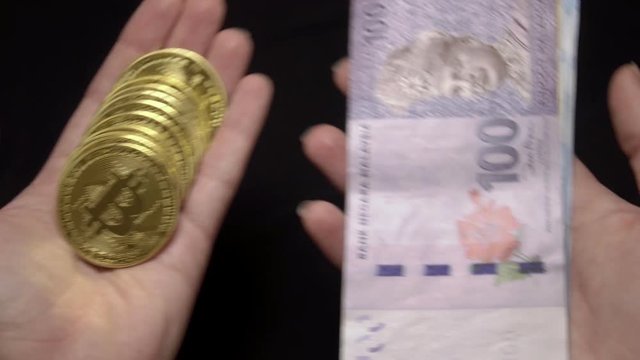 Weighting Bitcoins and Malaysian Ringgit Banknotes. National Currency of Malaysia. Digital Currency and Traditional Cash Money