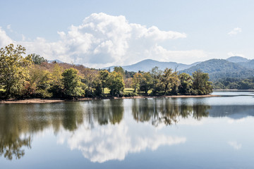 smokey mountain lake with clouds and reflection