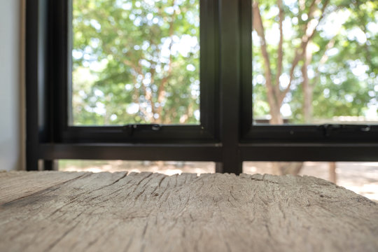 Closeup image of vintage wooden table foreground with blur background in cafe