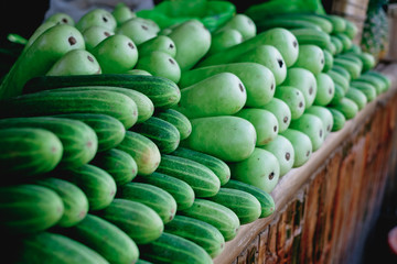 Array of green vegetables namely cucumber and calabash or also known as bottle gourd or...