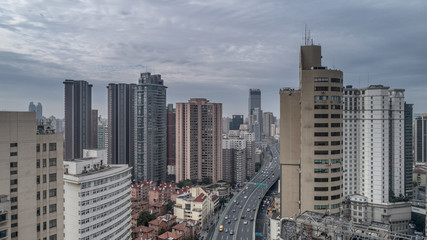Fototapeta na wymiar Aerial view of highway and buildings in West Yan`an road, Shanghai city on a cloudy day