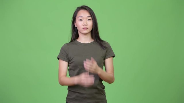Young beautiful Asian woman showing three wise monkeys concept
