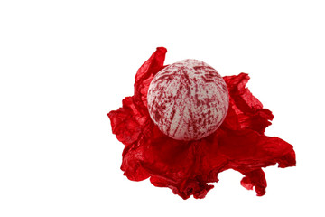 bomb bath.red  bomb bath on red crumpled paper isolated on white background.Organic Cosmetics for...