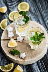 white rum.high angle view of cold fresh mojito cocktail in glasses on wooden surface.high angle view of cold fresh mojito cocktail in glasses on wooden surface.high angle view of cold fresh mojito coc