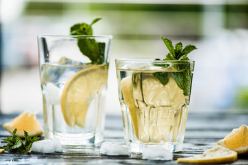 close-up view of fresh cold mojito cocktail in glasses on table