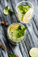 high angle view of fresh cold mojito cocktail in glasses on wooden table