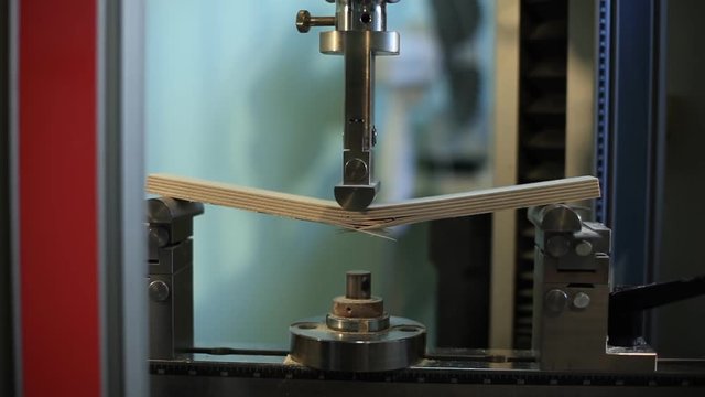 Equipment for mechanical testing of materials pushed on the piece of plywood and destroys it, figuring out the ultimate strength of the sample