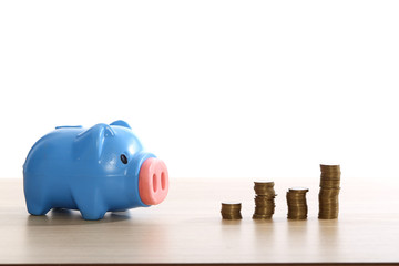 Plastic blue piggy bank with coins