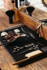 set of various professional barber tools and mirror in barbershop