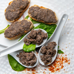 Toast of lamprey pie with bordelaise on white spoon