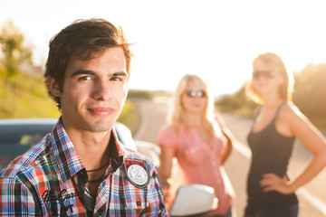junger Mann und Freunde an einem Cabrio