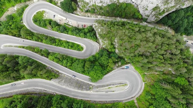 curved road with cars and beautiful forest landscape. Bicaz gorges, Romania. Aerial view from drone