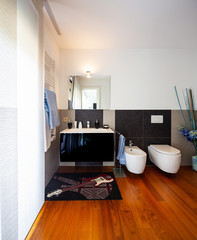 Modern bathroom with light and dark tiles