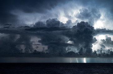 Lightning in the sea with high clouds