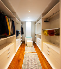 Walk-in closet with only male clothes