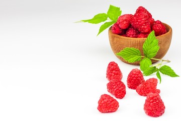 Fresh raspberries on a white background. Forest fruit. Healthy food. Sale of raspberries.