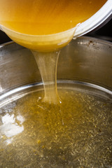 Strain the poured honey through a sieve. How to Harvest Honey. Filtering raw honey.