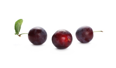 Wild red plums with leaf isolated on white background
