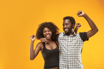 Winning success couple celebrating being a winner. Dynamic energetic image of afro models