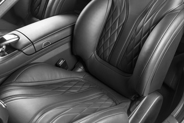 Modern Luxury car inside. Interior of prestige modern car. Comfortable leather seats. Perforated leather with isolated Black background. Modern car interior. Car detailing. Black and white