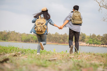 Hipster hiker young man and woman hiking holiday, wild adventure. Hiking in mountains inspirational landscape.