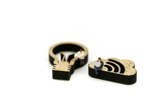 Miniature people : reading a book with sign of lamp idea and world map,Education business concept.
