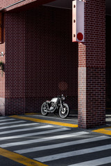 Vintage motorcycle parking near brick wall of finance building. Everything is ready for having fun...