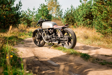 Silver vintage motorcycle parking on a country road. Everything is ready for having fun after hard...