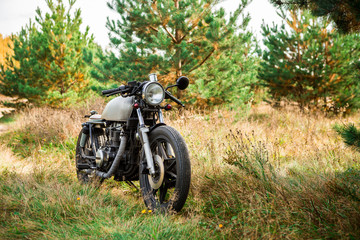 Silver vintage motorcycle parking on a country road. Everything is ready for having fun driving the...