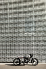 Caferacer motorcycle parking near wall of industrial building. Everything is ready for having fun...