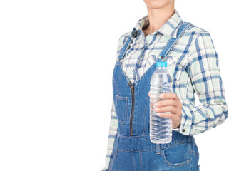young woman in plaid shirt and bib jeans holding bottle water isolated on white background