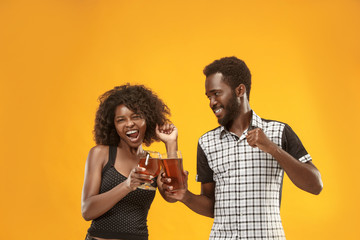 The afro couple or happy young people laughing and drinking beer at studio