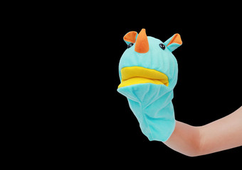 Hand wearing Rhinoceros puppets isolated on black background, Rhinoceros head.