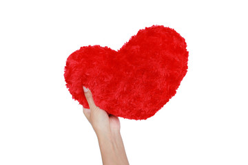 Close-up hand holding a red heart pillow isolated on white background.