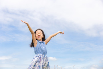 Happy beautiful child little girl white could and blue sky background with copy space