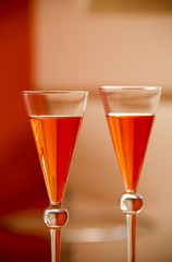 two orange cocktails with beautiful glass reflections