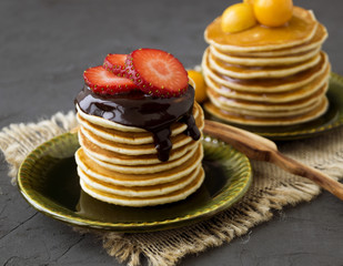 Pancakes with chocolate on a gray background