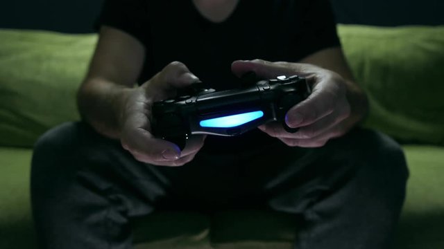 Man playing video game, Focus on game control