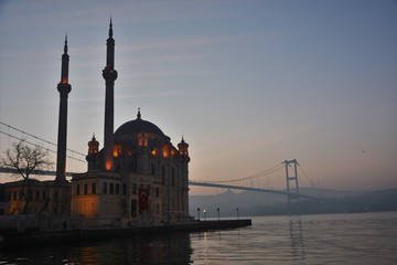 Fototapeta na wymiar Sunrise in Istanbul by Ortakoy Mosque and Bosphorus Bridge