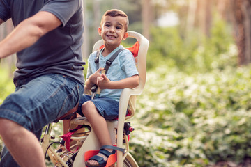 Family sport and healthy lifestyle- Happy boy on bicycle in park.