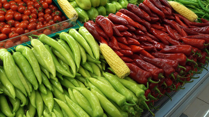 Vegetable shop. Rows of fresh vegetables, peppers, tomatoes and other vegetables lie on the shelves.