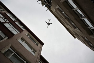 A plane is flying low over Balat houses