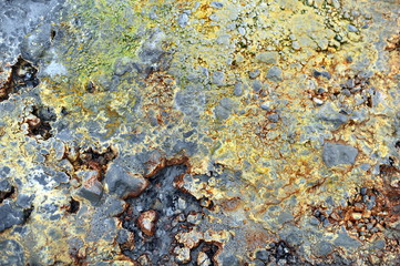 Multicolored smooth stones around the smoking fumarole