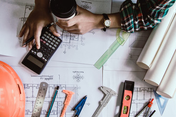 Concept architects, Hand of asian young woman engineer using calculator for calculation number of...