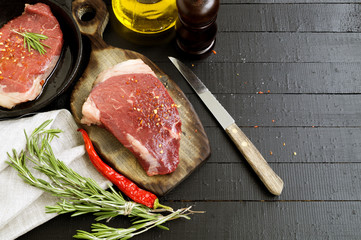 Raw meat. Raw beef steak on cutting Board and spices.